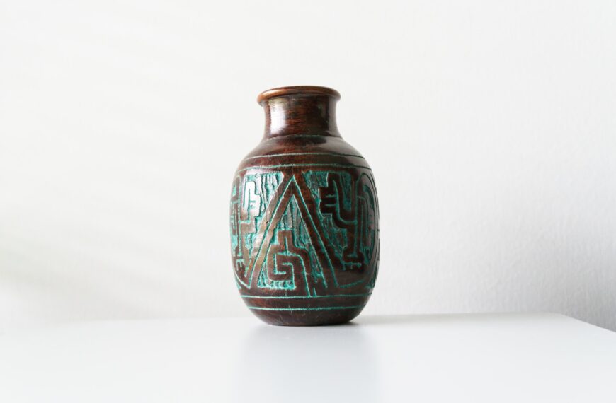 a glass vase with a blue and green design